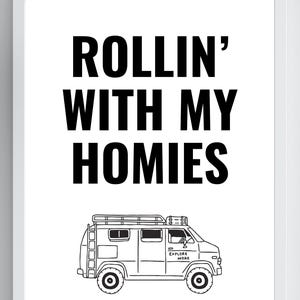 May include: Black and white framed print with the text "ROLLIN' WITH MY HOMIES" above a line drawing of a van. The van has a roof rack and the words "EXPLORE MORE" on the side.