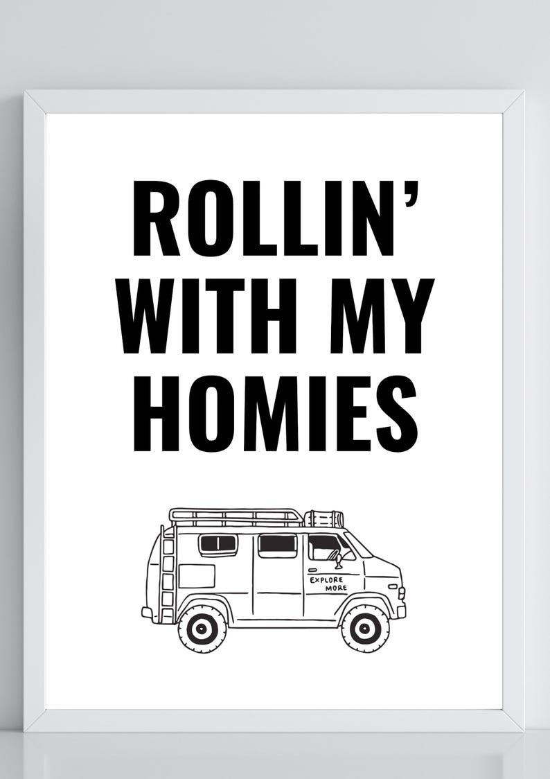 May include: Black and white framed print with the text "ROLLIN' WITH MY HOMIES" above a line drawing of a van. The van has a roof rack and the words "EXPLORE MORE" on the side.