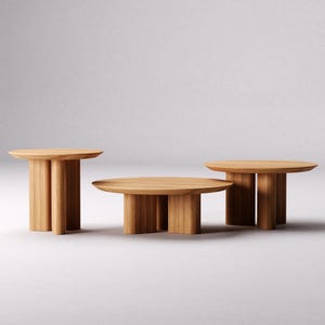 May include: Three wooden coffee tables with rounded tops and four legs each. The tables are arranged in a row, with the largest table in the center and the two smaller tables on either side.