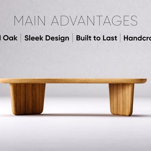 May include: A handcrafted solid oak bench with a sleek design. The bench features a rectangular top and two trapezoidal legs. The text "MAIN ADVANTAGES" and the words "Solid Oak | Sleek Design | Built to Last | Handcrafted" are displayed above the bench.