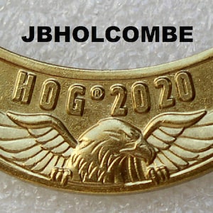 May include: Gold-colored HOG 2020 motorcycle club patch with a stylized eagle design and the text "JBHOLCOMBE" at the top.