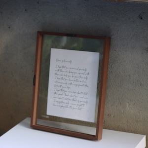 May include: A rectangular wooden floating frame containing a white paper insert with black cursive text that reads Dear future self, I hope that you surround yourself with those who bring you up and with those who help you be your true self.