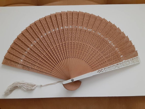 Old wooden fan with tassel