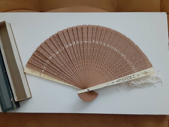 Old wooden fan with tassel