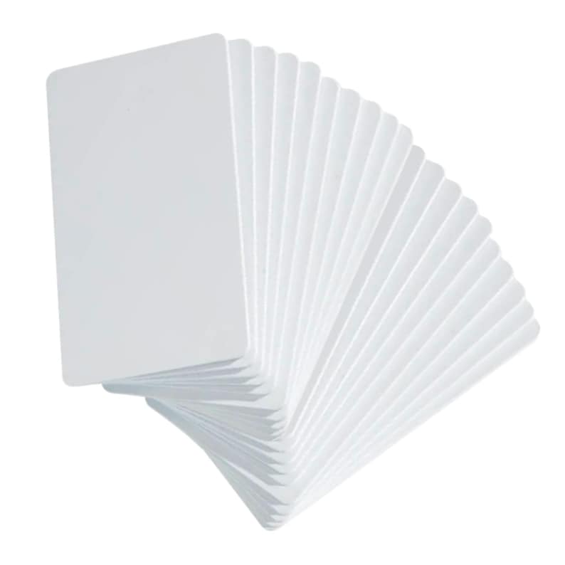 May include: A stack of blank, white rectangular cards, fanned out to display their edges. The cards have rounded corners and a smooth, clean surface. The cards are arranged in a semi-circular pattern against a white background.