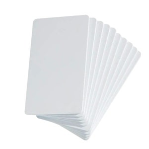 May include: A stack of blank, white rectangular cards with rounded corners. The cards are arranged in a fan shape, with one card slightly separated from the others. The cards are plain and have a smooth surface.