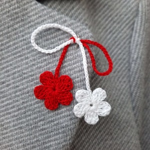 Martisor. Martisoare. Baba Marta. Martenitsa. Spring amulet. Moldova. Romanian martisor. Red and white flower. Traditional martisor.Märzchen