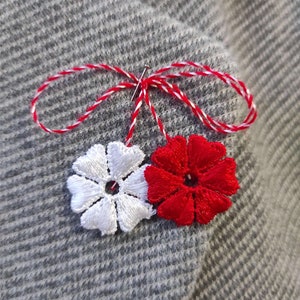 Martisor. Martisoare. Baba Marta. Martenitsa. Spring amulet. Moldova. Romanian martisor. Red and white flower. Traditional martisor.Märzchen