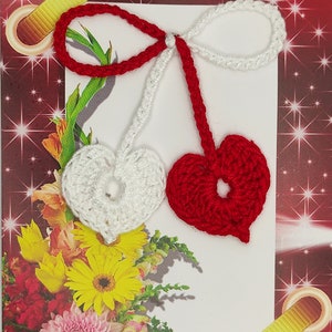 May include: A red and white crocheted martisor, a traditional Romanian charm, with the word "Martie" written on the card. The card also has the text "Primavara incepe cu un martisor!" which translates to "Spring begins with a martisor!"