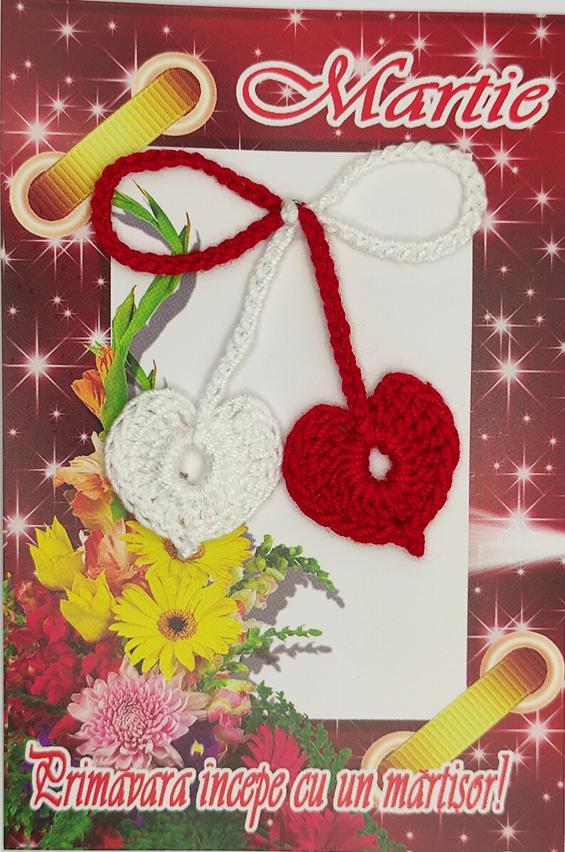 May include: A red and white crocheted martisor, a traditional Romanian charm, with the word "Martie" written on the card. The card also has the text "Primavara incepe cu un martisor!" which translates to "Spring begins with a martisor!"