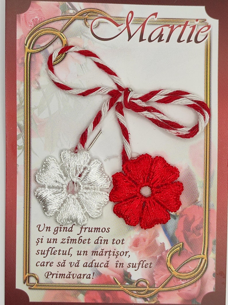 May include: A red and white martisor, a traditional Romanian charm, with a white embroidered flower and a red embroidered flower. The text on the card reads "Un g&icirc;nd frumos şi un z&icirc;mbet din tot sufletul, un mărţişor, care să vă aducă &icirc;n suflet Primăvara!"