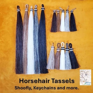 May include: An assortment of horsehair tassels in various colors, including black, brown, white, and gray. The tassels are displayed against a yellow background. Text on the image reads "Horsehair Tassels, Shoofly, Keychains and more."