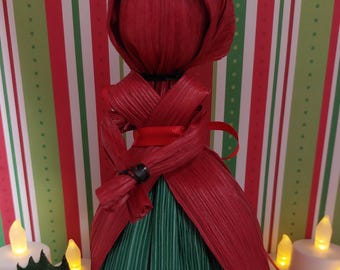 Red and green corn husk doll