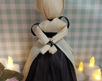 Black petticoat corn husk doll