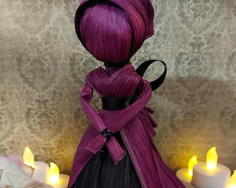 Raspberry and black corn husk doll