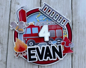 May include: Red, white, and black fire truck cake topper with a ladder, fire hydrant, and the name "EVAN" and the number "4".
