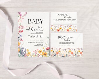 May include: A baby shower invitation with a floral design. The invitation says "Baby in Bloom" and includes the name "Taylor Smith". There are two additional cards with floral designs. One card says "Diapers Raffle" and the other says "Books for Baby".
