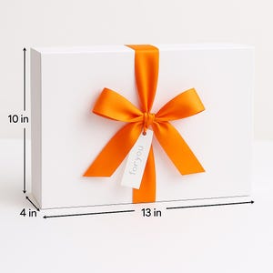 May include: A rectangular white gift box featuring a bright orange satin ribbon tied in a bow. A small white rectangular tag hangs from the ribbon with the text "foryou" printed on it. The box measures 10 inches in height, 13 inches in width, and 4 inches in depth.