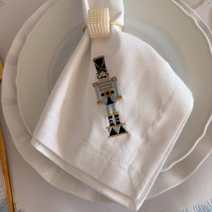 Christmas Nutcracker White Cotton Napkin – Elegant Holiday Table Décor Add a touch of festive charm to your table setting with our Stunning