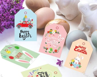 May include: A collection of Easter-themed gift tags in various pastel colors. The tags feature illustrations of Easter eggs, bunnies, and cars, with the words "Happy Easter" printed on them. Lilac flowers and decorative eggs are also present.