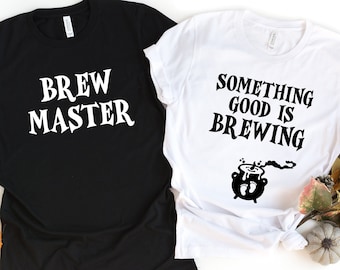 May include: Two black and white t-shirts with Halloween-themed text. One shirt says "Brew Master" and the other says "Something Good is Brewing" with a cauldron and steam graphic.