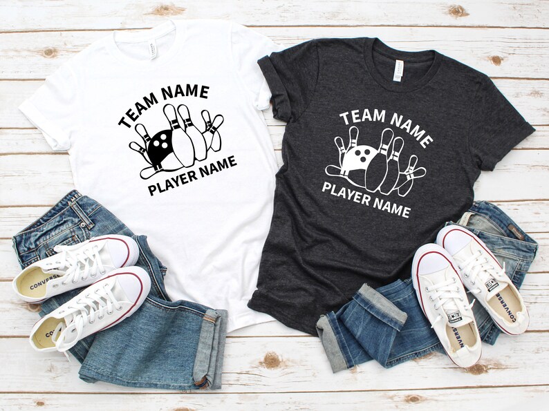 May include: Two t-shirts with a bowling ball and pins graphic. The text on the shirts reads "Team Name Player Name".