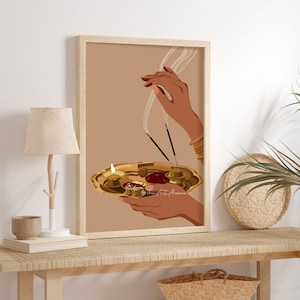 May include: A digital illustration of a hand holding a golden plate with lit candles and incense sticks. The background is a light brown color.