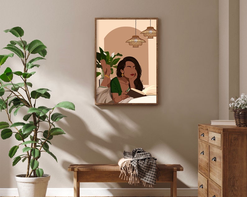 May include: A digital illustration of a woman reading a book in bed. The woman is wearing a green and gold sari and has her hair pulled back. The bed is white and there are two wicker pendant lights hanging above the bed.