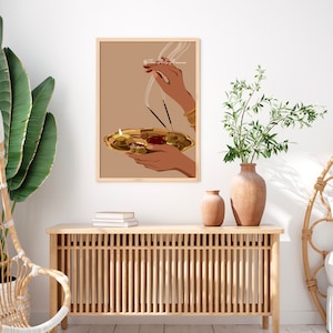 May include: A digital illustration of a person's hands holding a golden plate with burning incense sticks and a lit candle. The background is a light brown color.