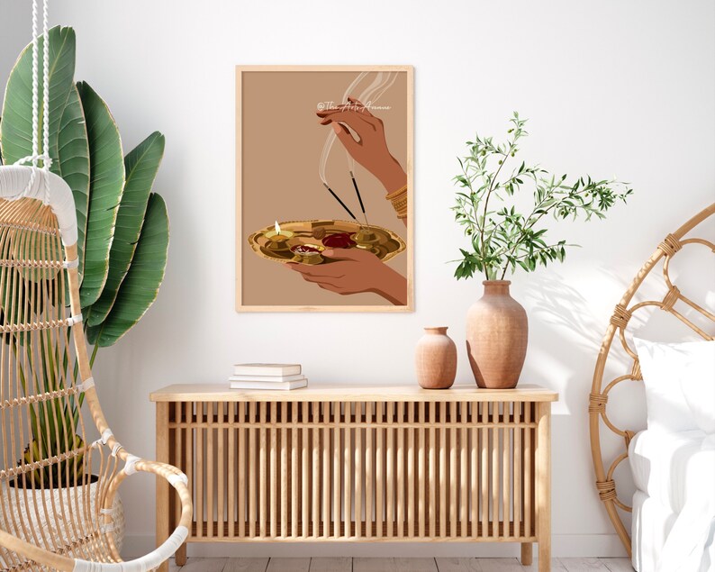 May include: A digital illustration of a person's hands holding a golden plate with burning incense sticks and a lit candle. The background is a light brown color.