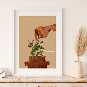 May include: A hand pours water from a golden pitcher onto a potted tulsi plant. The plant is in a terracotta pot with a decorative base. The background is a light brown color.