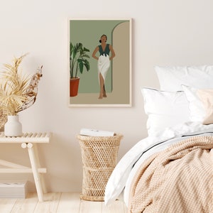 May include: A digital illustration of a woman standing in a doorway. She is wearing a green top and a white skirt. The background is a light green color. The illustration is framed and hanging on a white wall.
