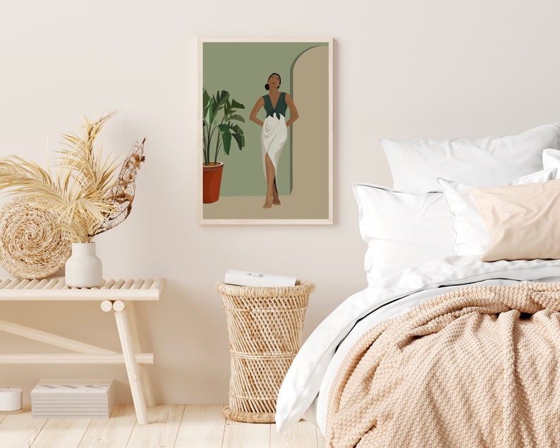 May include: A digital illustration of a woman standing in a doorway. She is wearing a green top and a white skirt. The background is a light green color. The illustration is framed and hanging on a white wall.