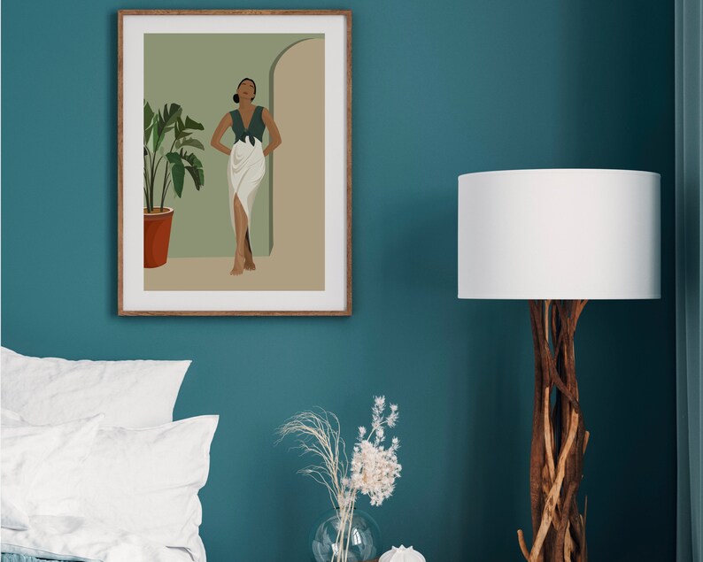 May include: A framed illustration of a woman standing in a doorway with a green plant in a terracotta pot. The woman is wearing a green top and a white skirt. The background is a light green color.