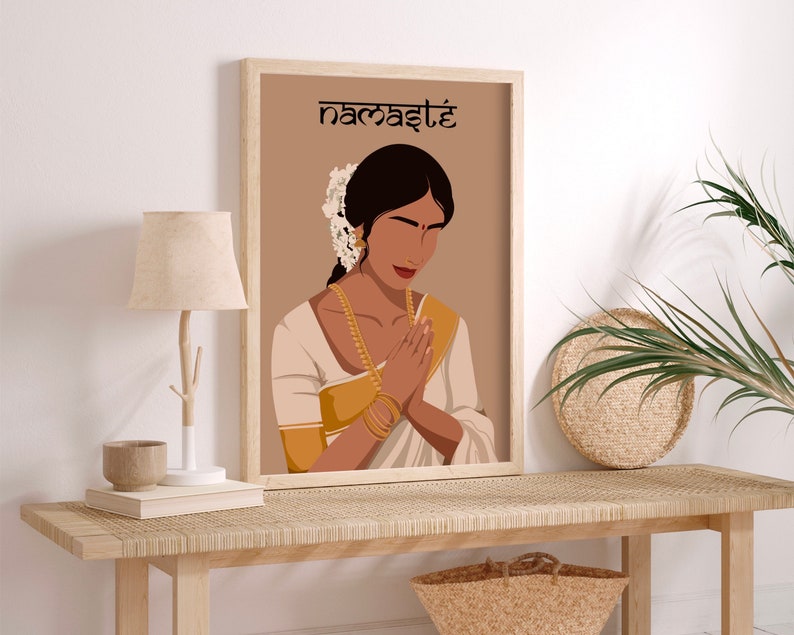 May include: A digital illustration of a woman in a white and gold sari with her hands in a prayer position. The background is a light brown color and the text "namaste" is written in black at the top of the image.