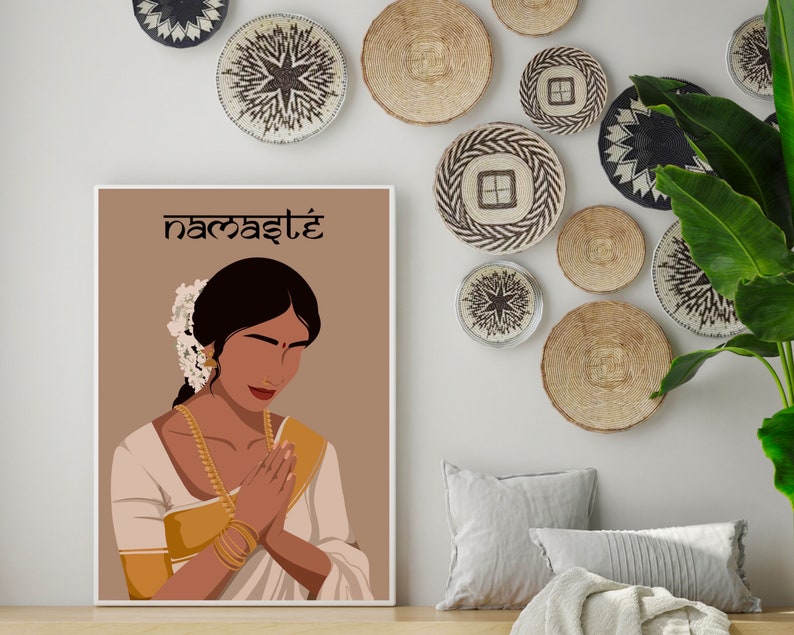May include: A digital illustration of a woman with dark hair and brown skin wearing a white and gold sari. She is holding her hands together in a prayer position. The background is a light brown color and the text "namaste" is written in black at the top of the image.