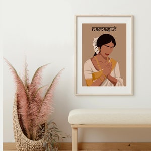 May include: A digital illustration of a woman in a white and gold sari with her hands clasped in a prayer position. The background is a light brown color and the text "namaste" is written in black at the top of the image.