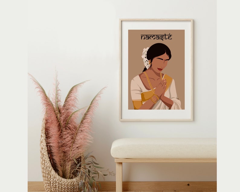 May include: A digital illustration of a woman in a white and gold sari with her hands clasped in a prayer position. The background is a light brown color and the text "namaste" is written in black at the top of the image.