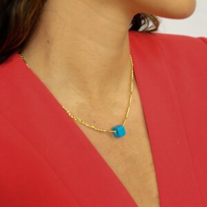 Gold figaro chain necklace with blue cube charm