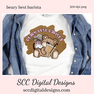 May include: A white t-shirt with a brown and white design featuring a teddy bear holding a cup of coffee. The design includes the text "Beary Best Barista" in pink letters.