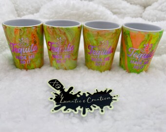 May include: Four yellow and orange shot glasses with a white rim. Each glass has the text "Tequila Made Me Do It" and a lime wedge graphic.