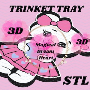 May include: A pink and white cartoon trinket tray design. The words "TRINKET TRAY" and "STL" are in black. The design features a cartoon character with a pink bow, a pink skirt with blue hearts, and the words "Magical Dream Heart".
