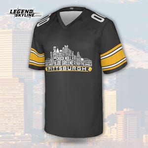 May include: Black football jersey with gold and white accents. The jersey features a V-neck and the number "0" on the shoulders. The front displays a white skyline graphic with the word "Pittsburgh" and player names.