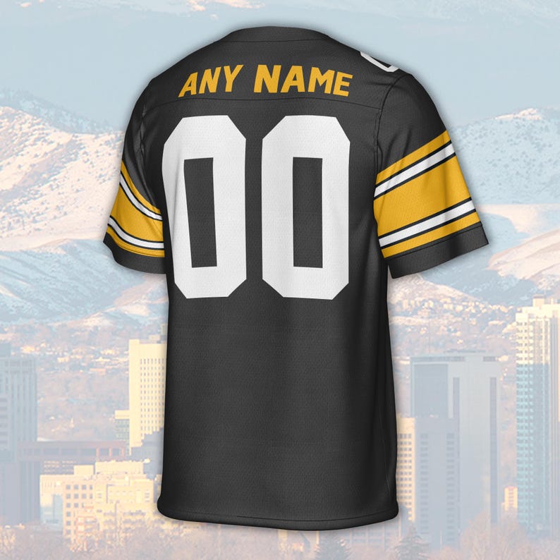 May include: Black football jersey with white numbers and the text "ANY NAME" in gold. The jersey has gold and white stripes on the sleeves. The number "00" is prominently displayed on the back.