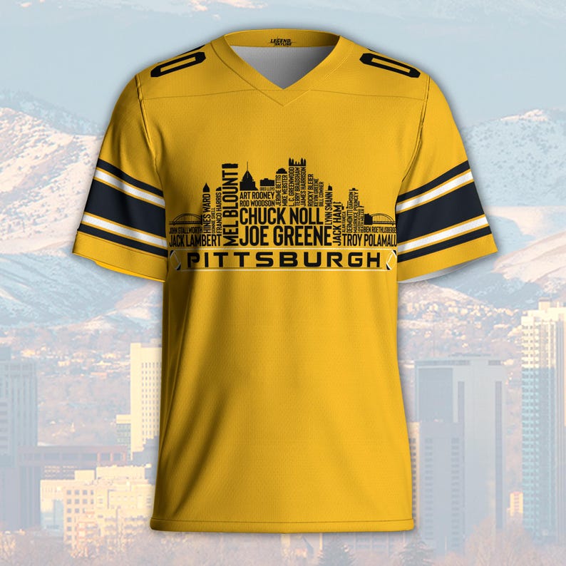 May include: A yellow V-neck jersey with black and white stripes on the sleeves. The jersey features a black silhouette of a city skyline with the word "PITTSBURGH" and names of famous players.