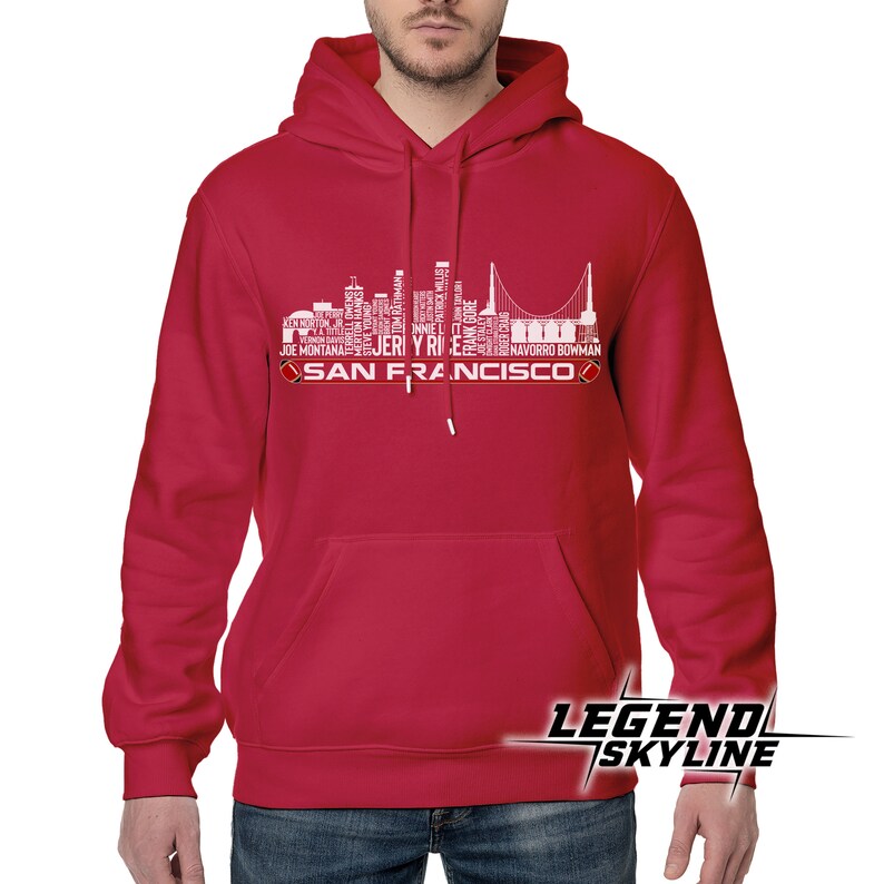 May include: Red hooded sweatshirt with a white graphic of the San Francisco skyline made up of the names of famous athletes and the text "SAN FRANCISCO".