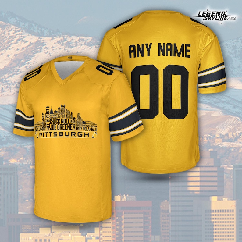 May include: A yellow football jersey with black and white stripes on the sleeves. The front features a Pittsburgh skyline graphic with player names. The back displays "ANY NAME" above the number "00".