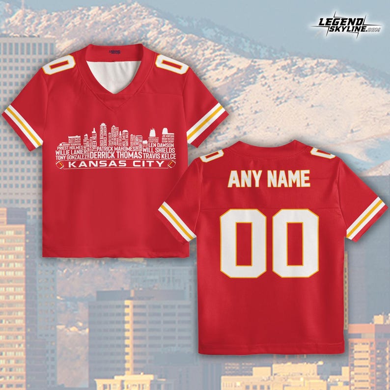 May include: Red jersey with white and yellow stripes. The front features a white skyline graphic with player names and "KANSAS CITY." The back has "ANY NAME" above the number "00."