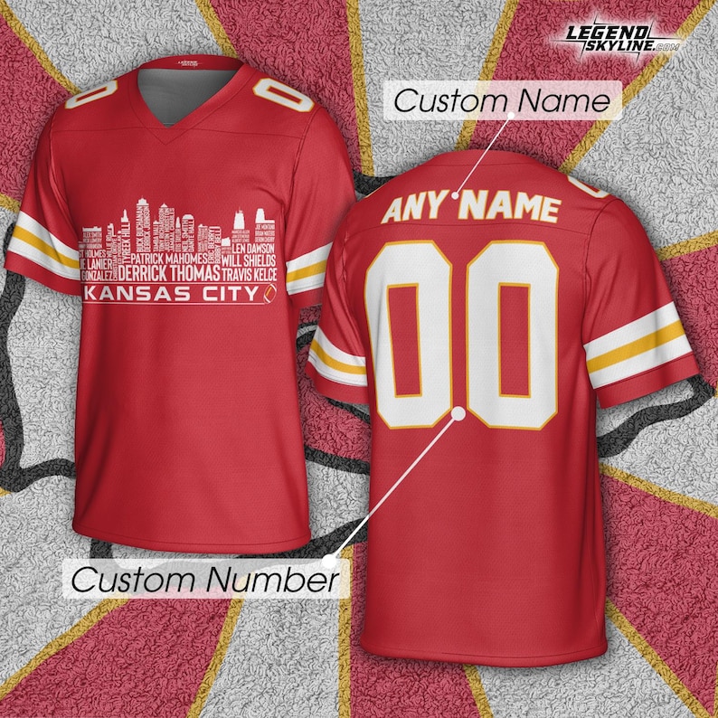 May include: Red football jersey with white and yellow accents. The front features a white skyline graphic with player names and "Kansas City" text. The back displays "ANY NAME" above the number "00".