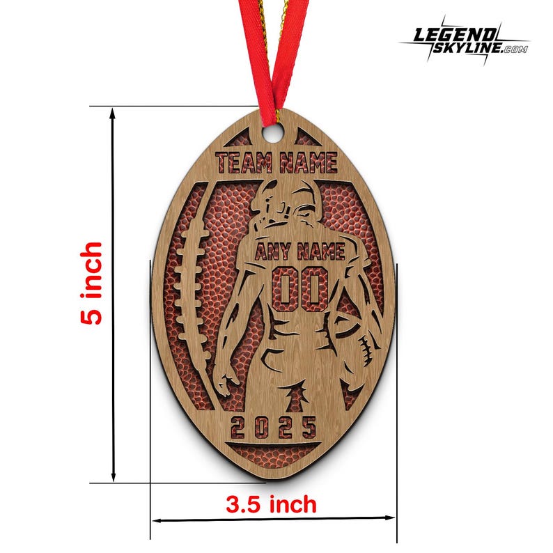 May include: A wooden American football-shaped ornament, 12.7 cm tall and 8.9 cm wide, with a red ribbon. The ornament features a football player silhouette, the text "TEAM NAME", "ANY NAME", "00", and "2025". The background has a red football texture.